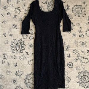 Black, mid length, tight fitting dress
